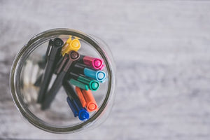 jar containing colorful pens used for planning and journaling